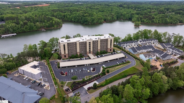drone / aerial view with a water view and a forest view
