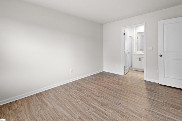 1228 Nnorwhich Ln, Spartanburg, SC 29301 - unfurnished bedroom featuring baseboards, ensuite bath, and light wood-style flooring