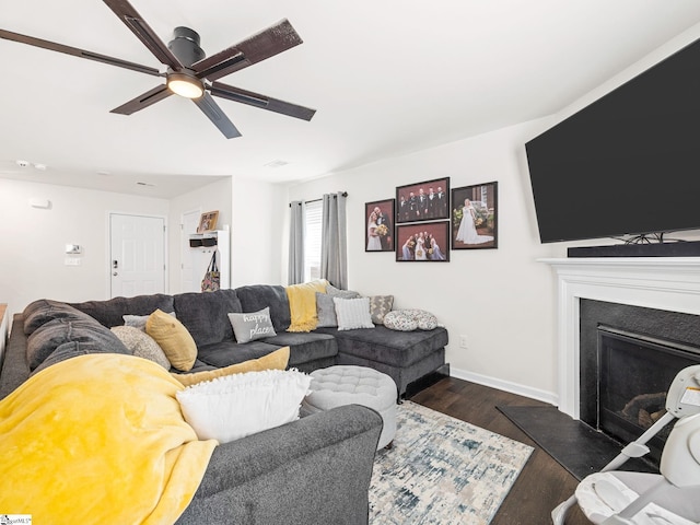 1087 Summerlin Trl, Duncan, SC 29334 - living area with a fireplace with raised hearth, ceiling fan, baseboards, and dark wood-type flooring
