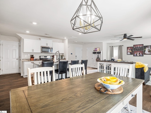 1087 Summerlin Trl, Duncan, SC 29334 - dining room featuring recessed lighting, ceiling fan with notable chandelier, and dark wood-type flooring