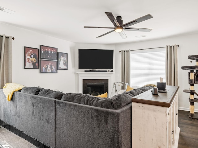1087 Summerlin Trl, Duncan, SC 29334 - living room featuring ceiling fan, a glass covered fireplace, visible vents, baseboards, and dark wood finished floors