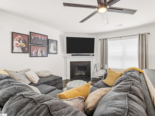 1087 Summerlin Trl, Duncan, SC 29334 - living area featuring a glass covered fireplace, visible vents, wood finished floors, and a ceiling fan