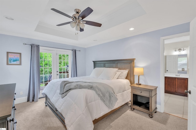 bedroom featuring access to outside, a tray ceiling, crown molding, light carpet, and baseboards