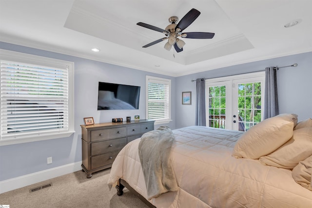bedroom featuring a raised ceiling, french doors, crown molding, and access to exterior