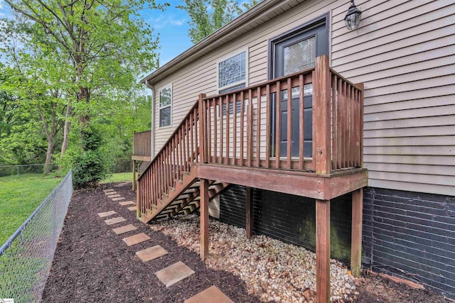wooden terrace featuring stairway and fence