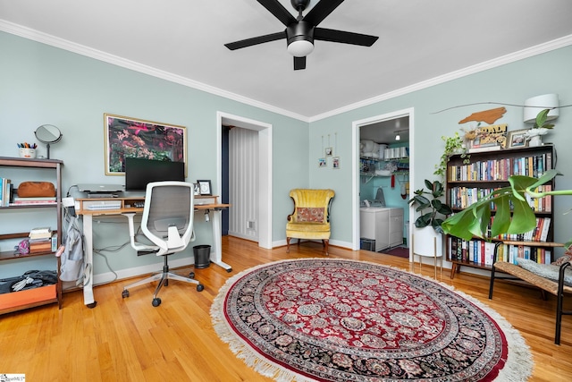 office area featuring wood finished floors, independent washer and dryer, baseboards, a ceiling fan, and crown molding