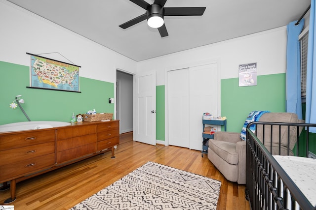 bedroom featuring a closet, a ceiling fan, and wood finished floors
