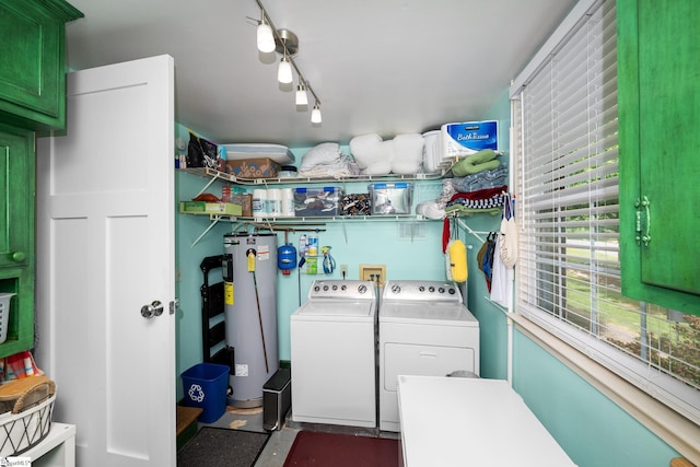 washroom with cabinet space, separate washer and dryer, and electric water heater