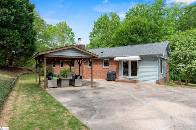 back of house with a patio, an outdoor living space, a chimney, and a shingled roof