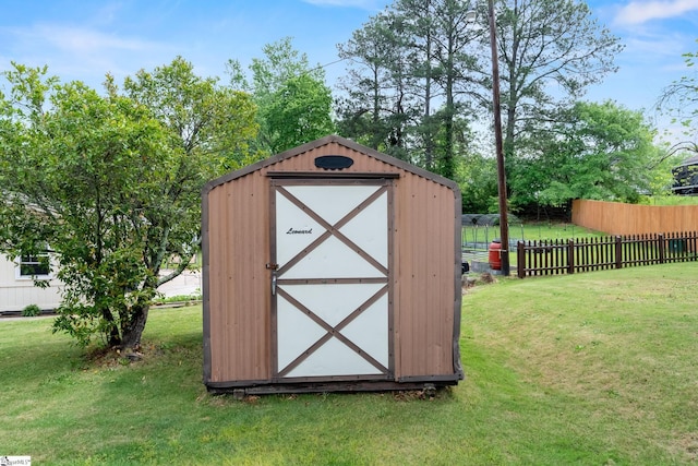 view of shed featuring fence