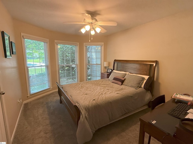 carpeted bedroom featuring ceiling fan and baseboards
