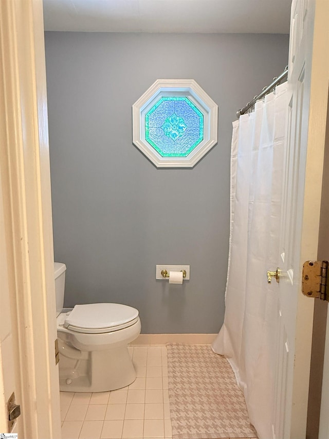 full bathroom featuring toilet and tile patterned flooring
