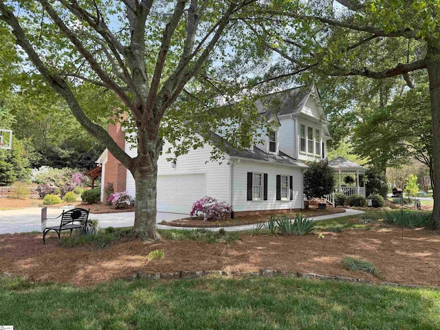 view of home's exterior with concrete driveway