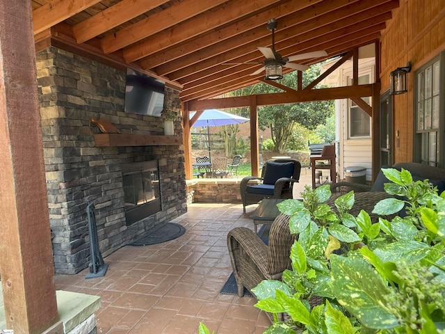 view of patio / terrace with ceiling fan and an outdoor stone fireplace