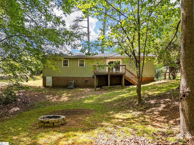 back of house featuring a deck, crawl space, stairs, and an outdoor fire pit