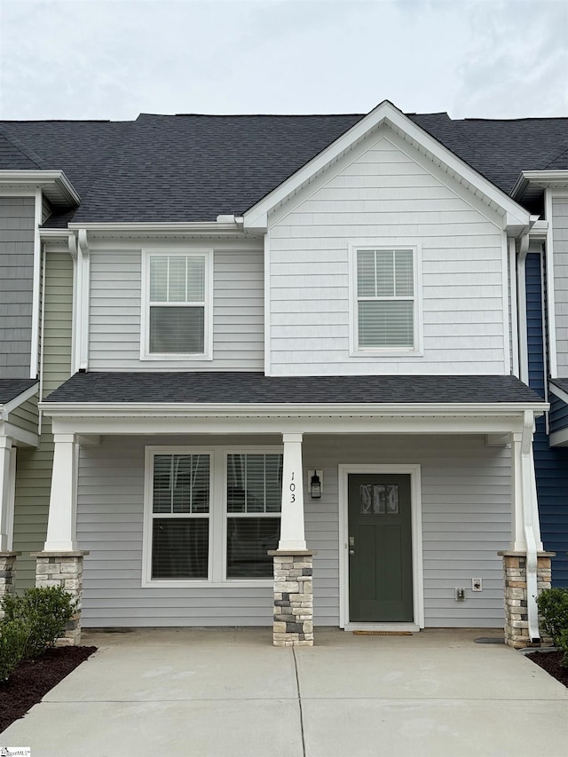 view of front of house with a shingled roof and covered porch