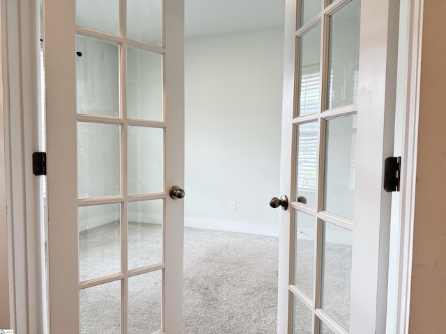 interior space with french doors, baseboards, and carpet floors