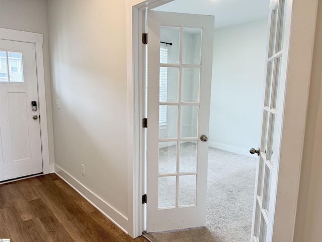 foyer entrance featuring baseboards, french doors, dark wood-style flooring, and plenty of natural light