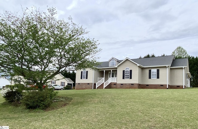ranch-style home with roof with shingles, covered porch, crawl space, and a front lawn