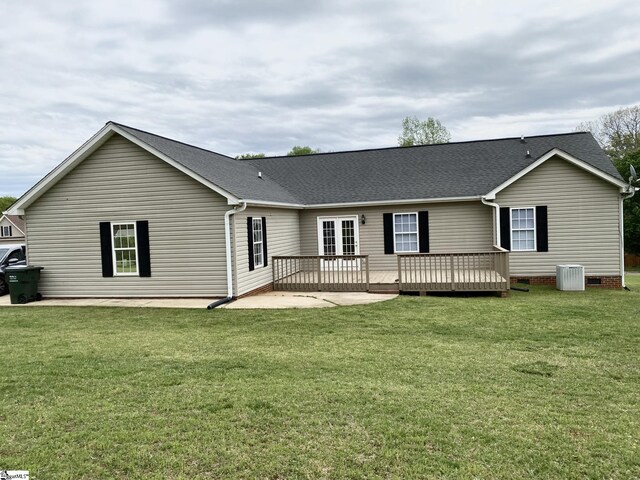 back of house with a deck, a yard, central AC, and roof with shingles