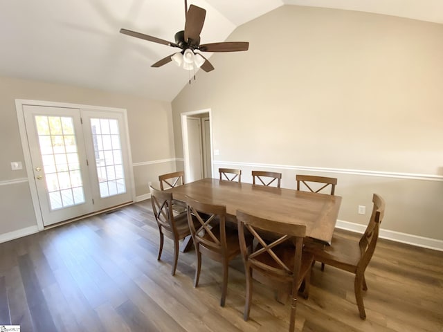 dining room featuring baseboards, wood finished floors, ceiling fan, and vaulted ceiling