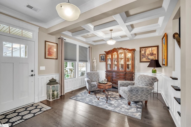 foyer featuring beamed ceiling, visible vents, a wainscoted wall, coffered ceiling, and dark wood-style flooring