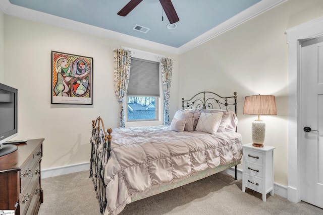 bedroom featuring ceiling fan, visible vents, baseboards, ornamental molding, and light colored carpet