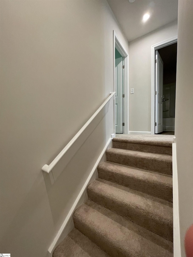 stairway featuring baseboards