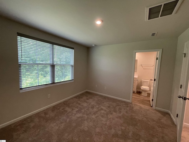 unfurnished bedroom with visible vents, carpet flooring, and baseboards