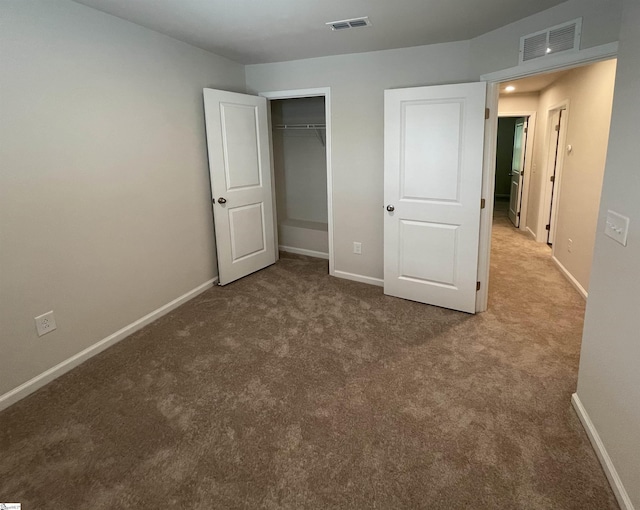 unfurnished bedroom with baseboards, visible vents, carpet floors, and a closet