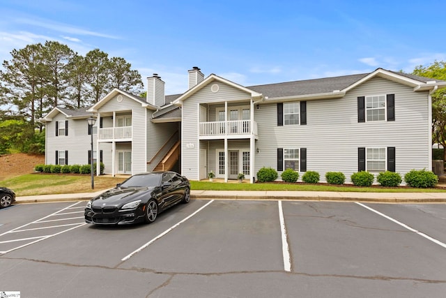 view of property featuring uncovered parking