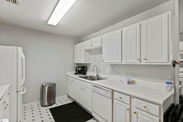 kitchen featuring a sink, white cabinets, and white appliances
