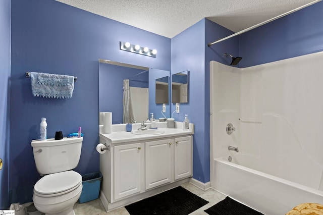bathroom featuring vanity, toilet, baseboards, a textured ceiling, and shower / washtub combination