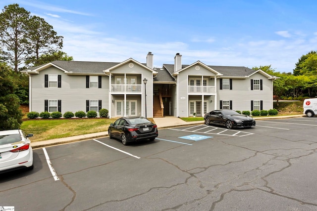 view of property with uncovered parking