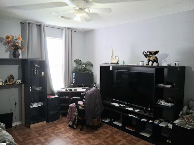 living room with visible vents and ceiling fan