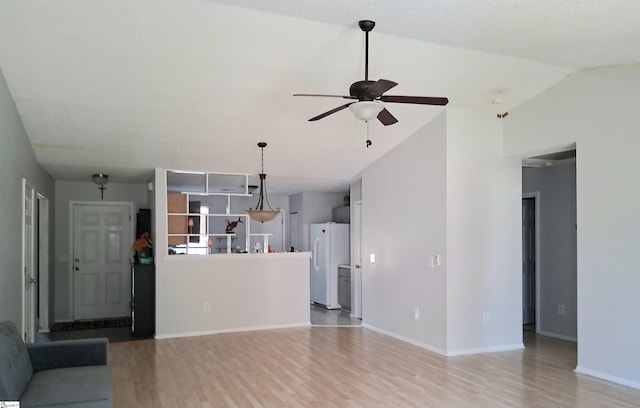 unfurnished living room featuring lofted ceiling, ceiling fan, light wood-type flooring, and baseboards