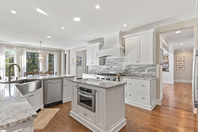 kitchen with decorative backsplash, stainless steel appliances, a kitchen island, premium range hood, and ornamental molding