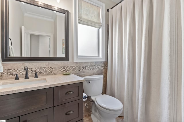 bathroom with ornamental molding, toilet, and vanity