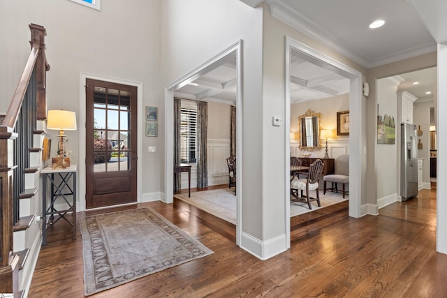 entryway featuring beam ceiling, crown molding, coffered ceiling, baseboards, and wood finished floors