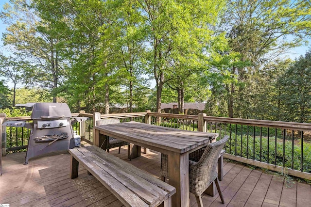 wooden deck with area for grilling and outdoor dining space