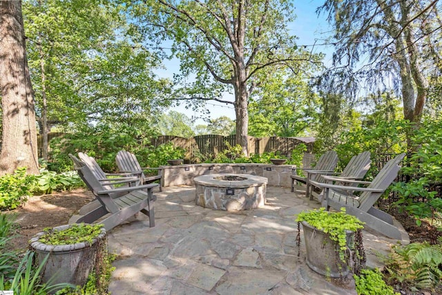 view of patio / terrace with fence and an outdoor fire pit