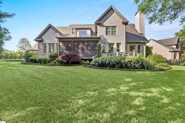 back of property featuring a sunroom, fence, a yard, and a chimney