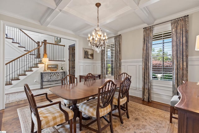 dining area with a chandelier, coffered ceiling, beam ceiling, wood finished floors, and stairs