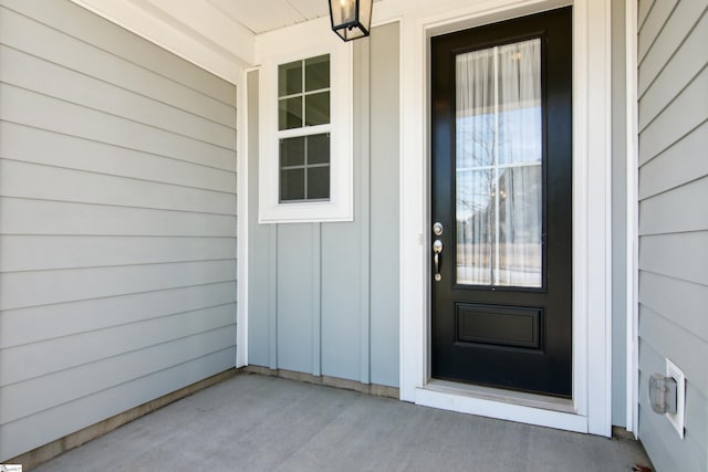 doorway to property featuring covered porch and board and batten siding