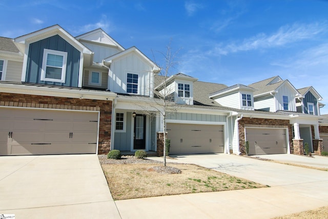 view of front of property featuring board and batten siding, a shingled roof, concrete driveway, and stone siding