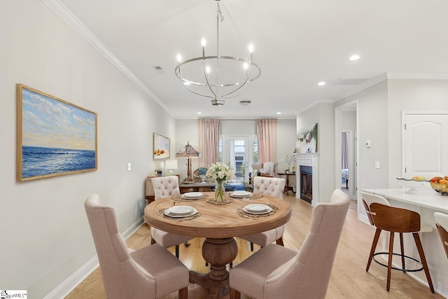 dining space featuring baseboards, recessed lighting, light wood finished floors, ornamental molding, and a notable chandelier