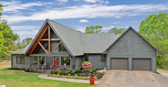 view of front of home with aphalt driveway, a shingled roof, a front yard, an attached garage, and a porch