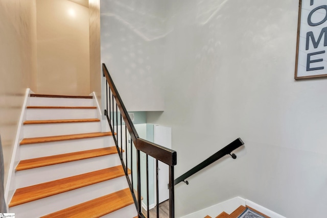 staircase featuring baseboards