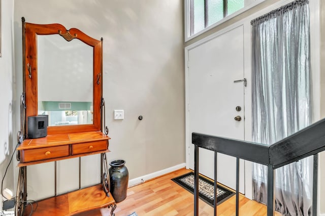foyer entrance featuring wood finished floors and baseboards