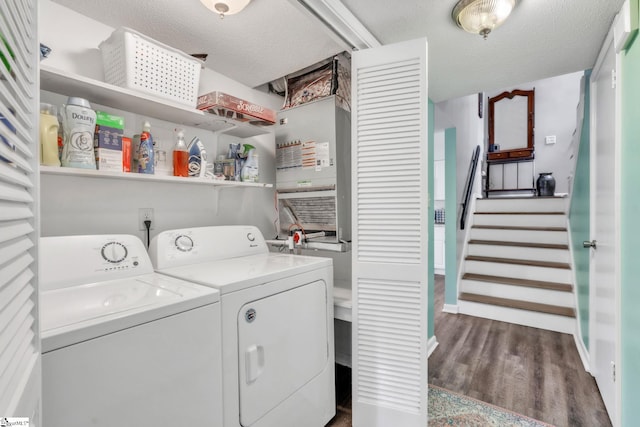 laundry area featuring wood finished floors, independent washer and dryer, laundry area, and a textured ceiling